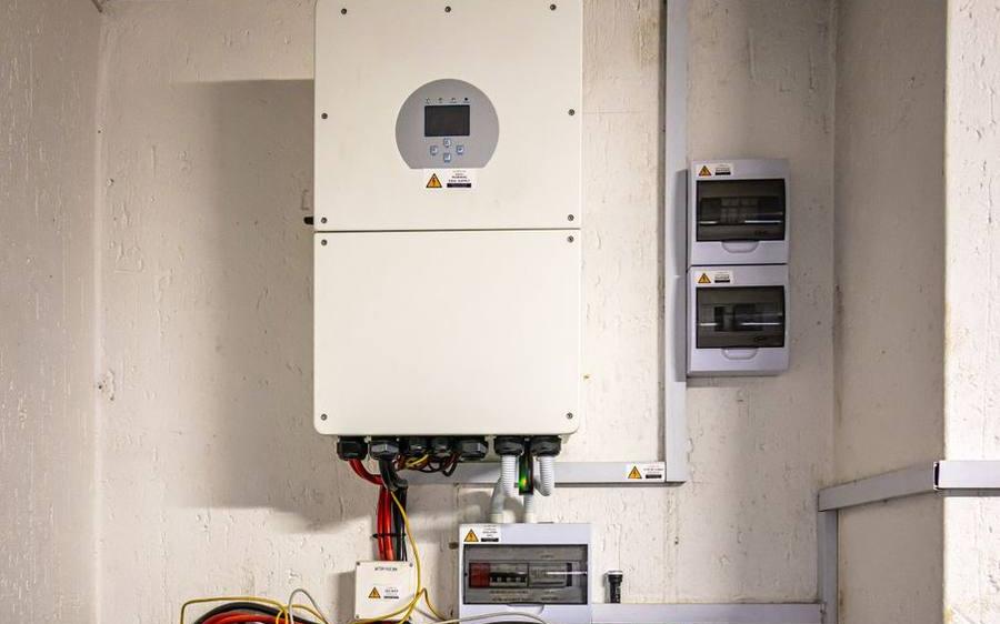A hybrid inverter mounted on a wall